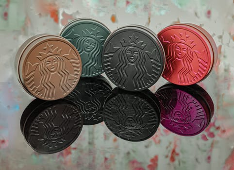 Bangkok, Thaiand May 5, 2023 - The Colorful of Metal round boxes on floral patterned curtains background. Which are the Collection Series of Starbucks. They are for keeping snacks or some accessories which are reflected. Space for text,