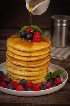 Recipe for maple syrup pancakes with raspberry and blueberry filling, High quality photo