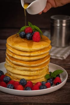 Recipe for maple syrup pancakes with raspberry and blueberry filling, High quality photo