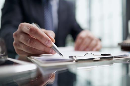 man hands with pen writing on notebook in the office.learning, education and work