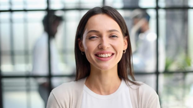 Face of beautiful woman on the background of business people
