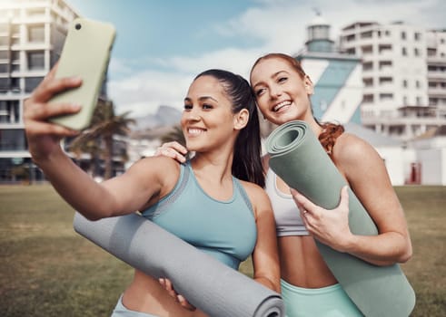 Yoga, fitness and selfie with woman friends in the park together for mental health exercise. Pilates, social media and training with a female and friend outside on a grass field for a summer workout.