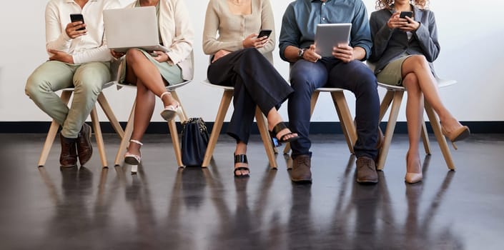 Technology, legs and people waiting for an interview in line at a human resources office as candidates for a vacancy. We are hiring, recruitment and opportunity with man and woman employees online.