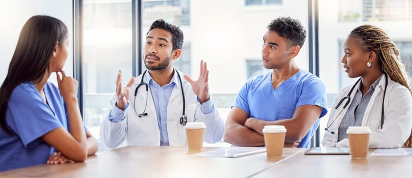 Meeting, coaching and healthcare with a doctor and team in a hospital boardroom for training or discussion. Teamwork, leadership or learning with a medicine professional talking to nurses in a clinic.