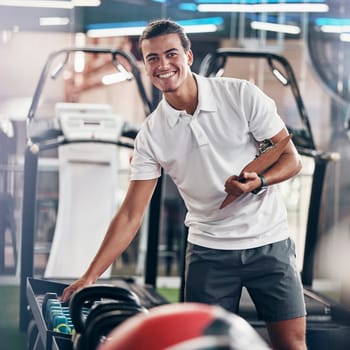 Training, portrait and fitness coach doing inspection of equipment at the gym. Wellness, sport and happy trainer doing check, planning and working at a club for athlete health, sports and workout.