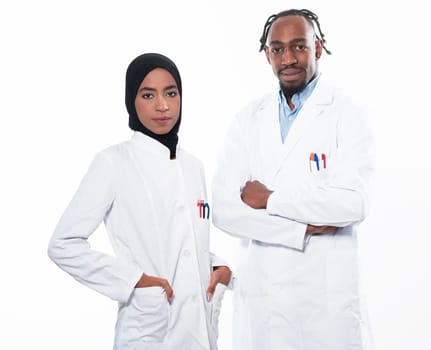 Closeup front view of group of mixed age doctors and nurses standing side by side and looking at the camera. Young Middle Eastern female in a team with African American black doctor. High quality photo