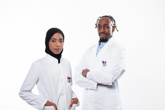 Closeup front view of group of mixed age doctors and nurses standing side by side and looking at the camera. Young Middle Eastern female in a team with African American black doctor. High quality photo