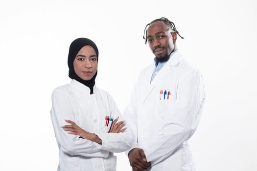 Closeup front view of group of mixed age doctors and nurses standing side by side and looking at the camera. Young Middle Eastern female in a team with African American black doctor. High quality photo