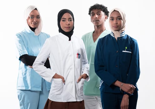 Closeup front view of group of mixed age doctors and nurses standing side by side and looking at the camera. Young Middle Eastern female in a team with African American black doctor. High quality photo