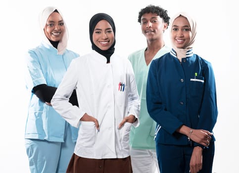 Closeup front view of group of mixed age doctors and nurses standing side by side and looking at the camera. Young Middle Eastern female in a team with African American black doctor. High quality photo