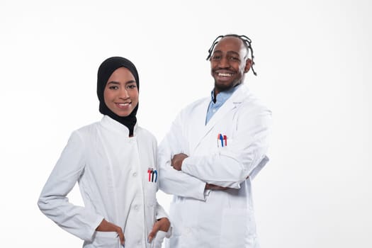 Closeup front view of group of mixed age doctors and nurses standing side by side and looking at the camera. Young Middle Eastern female in a team with African American black doctor. High quality photo