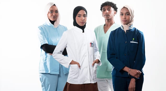 Closeup front view of group of mixed age doctors and nurses standing side by side and looking at the camera. Young Middle Eastern female in a team with African American black doctor. High quality photo