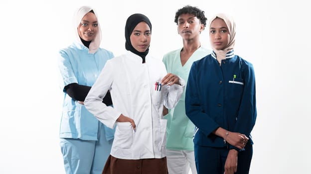 Closeup front view of group of mixed age doctors and nurses standing side by side and looking at the camera. Young Middle Eastern female in a team with African American black doctor. High quality photo