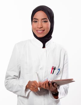 Portrait of muslim female nurse. Authentic Confident Middle Eastern Healthcare Worker. Middle age senior Arab nurse woman wearing hijab over isolated background. High quality photo