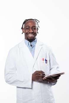 Doctor dark skin guy virologist agent corona virus seminar conference arms crossed pandemic virus expert wear white lab coat isolated white color background using a tablet computer. High quality photo