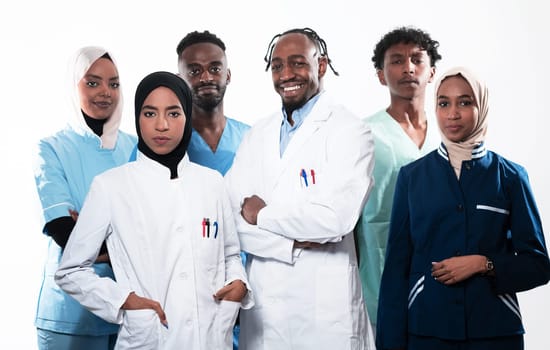 Team or group of a doctor, nurse and medical professional coworkers standing together. Portrait of diverse healthcare workers looking confident. Middle Eastern and African, Muslim medical team. High quality photo