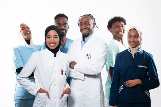 Team or group of a doctor, nurse and medical professional coworkers standing together. Portrait of diverse healthcare workers looking confident. Middle Eastern and African, Muslim medical team. High quality photo