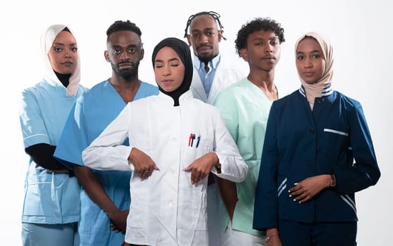 Team or group of a doctor, nurse and medical professional coworkers standing together. Portrait of diverse healthcare workers looking confident. Middle Eastern and African, Muslim medical team. High quality photo