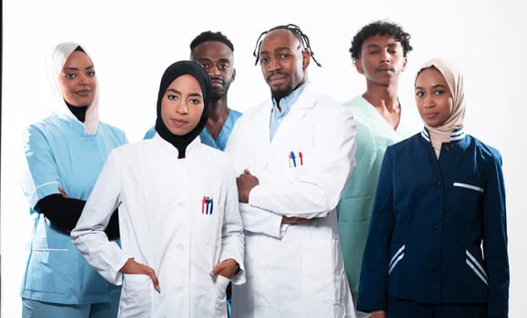 Team or group of a doctor, nurse and medical professional coworkers standing together. Portrait of diverse healthcare workers looking confident. Middle Eastern and African, Muslim medical team. High quality photo