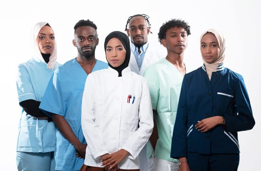 Team or group of a doctor, nurse and medical professional coworkers standing together. Portrait of diverse healthcare workers looking confident. Middle Eastern and African, Muslim medical team. High quality photo