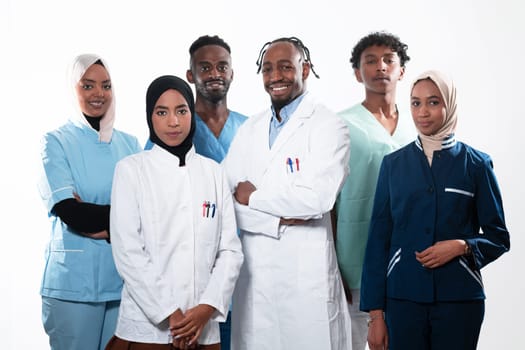 Team or group of a doctor, nurse and medical professional coworkers standing together. Portrait of diverse healthcare workers looking confident. Middle Eastern and African, Muslim medical team. High quality photo