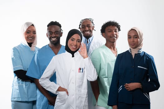 Team or group of a doctor, nurse and medical professional coworkers standing together. Portrait of diverse healthcare workers looking confident. Middle Eastern and African, Muslim medical team. High quality photo