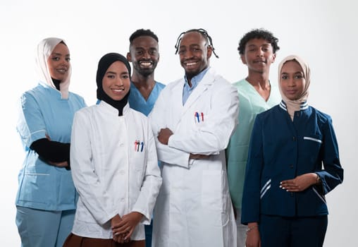 Team or group of a doctor, nurse and medical professional coworkers standing together. Portrait of diverse healthcare workers looking confident. Middle Eastern and African, Muslim medical team. High quality photo