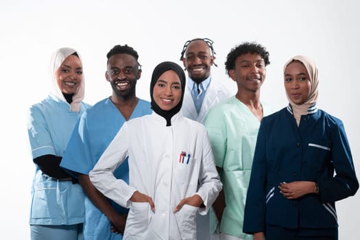 Team or group of a doctor, nurse and medical professional coworkers standing together. Portrait of diverse healthcare workers looking confident. Middle Eastern and African, Muslim medical team. High quality photo