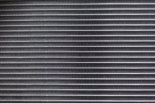 Texture of a car radiator. Engine cooler background. Vintage style. Radiator grille for car interior heater air conditioner, close-up. Radiator repair and replacement.