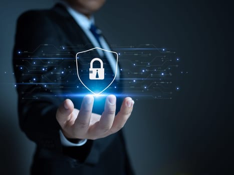 Businessman holding a protection sign. Represents protection against external hacks. Concepts of protection against code, viruses, firmware and malware.