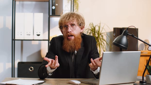 I dont know what to say. Confused business man working on laptop at office workplace. Freelancer feeling embarrassed about ambiguous question, having doubts, no answer idea, being clueless, uncertain
