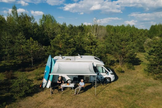 The family is resting in their race track located in the forest in sunny weather.