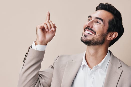 man businessman success winner victory arm beige business background suit male smile young celebrate cheerful person hand confident posing happy stylish