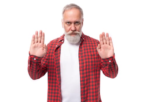 handsome 60s elderly man with gray beard showing stop gesture.
