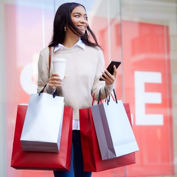 Phone, coffee and woman with shopping bags in city with posh, rich and fancy lifestyle. Fashion, young and female person walking in town after sale purchase from store with cellphone and cappuccino
