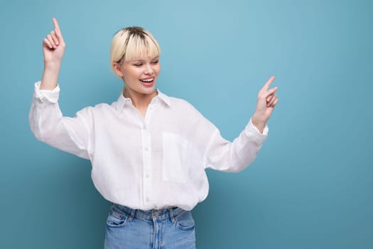 young pretty blond secretary woman dressed in a white shirt on a blue background with copy space.