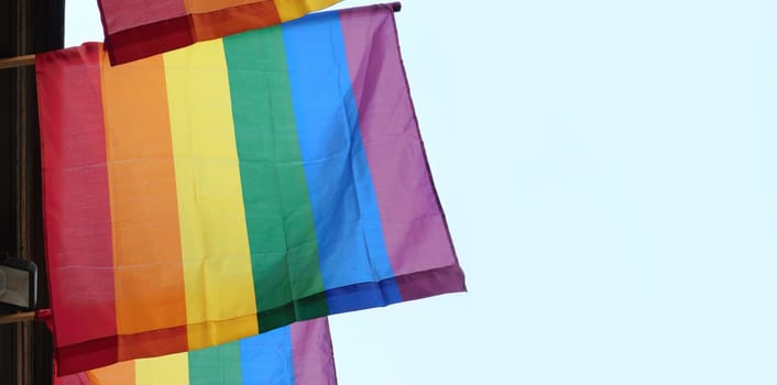 The rainbow flag, gay pride or LGBTQ symbol on light