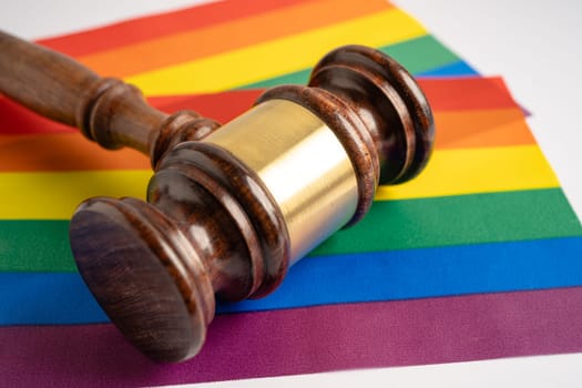 Gavel for judge lawyer on rainbow flag, symbol of LGBT pride month celebrate annual in June social of gay, lesbian, bisexual, transgender, human rights.