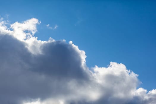 Big white clouds in a blue sky close-up. There is a place for the text. The concept of cleanliness in nature and caring for nature