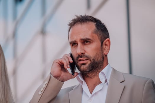 A businessman using his smartphone outdoors, showcasing the seamless integration of technology and mobility in modern professional life