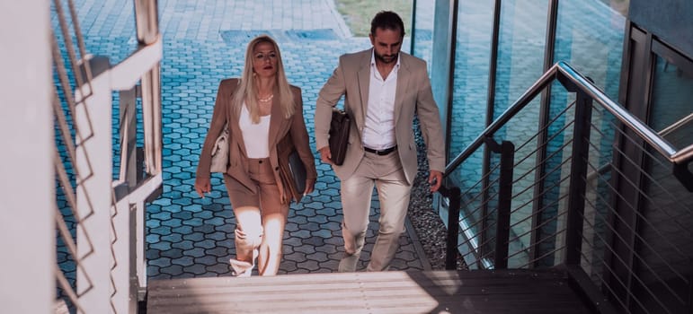 Modern business couple after a long day's work, walking together towards the comfort of their home, embodying the perfect blend of professional success and personal contentment