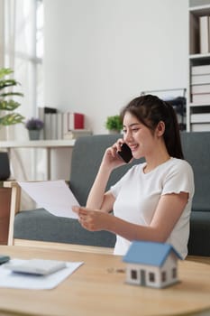 Asian accounting professional calculating household bills, reviewing and analyzing household bills, and filing tax returns.