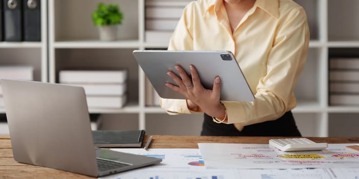 Accountant asian woman working on tablet and do document, tax, exchange, accounting and Financial advisor concept.