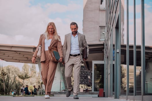 Modern business couple after a long day's work, walking together towards the comfort of their home, embodying the perfect blend of professional success and personal contentment