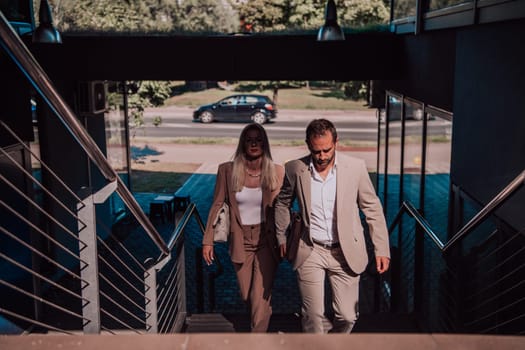 Modern business couple after a long day's work, walking together towards the comfort of their home, embodying the perfect blend of professional success and personal contentment