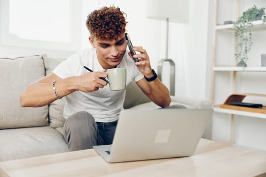 man interior adult lifestyle smile mockup text young technology male cellphone freelancer curly phone smartphone internet student holding