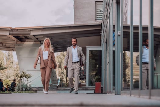 Modern business couple after a long day's work, walking together towards the comfort of their home, embodying the perfect blend of professional success and personal contentment