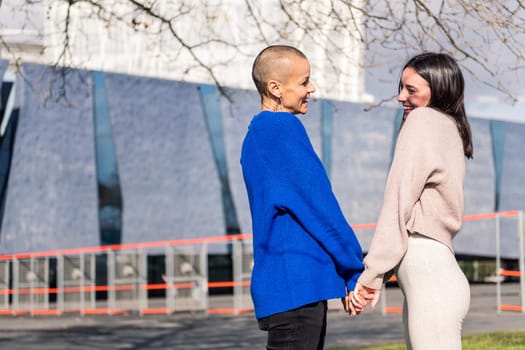 lesbian couple of two women smiling happy looking in love in to the eyes, concept of freedom and love between people of the same sex