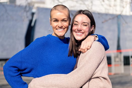 portrait of a couple of two young women embracing looking at camera, concept of friendship