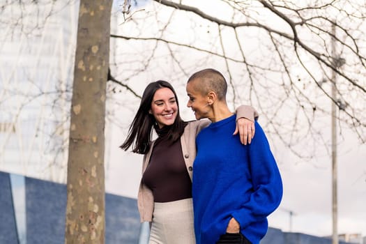 lesbian couple of two young women smiling happy taking a romantic walk, concept of freedom and love between people of the same sex